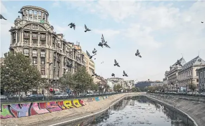  ?? IOANA MOLDOVAN THE NEW YORK TIMES ?? A view of the Dambovita River near Unirii Square in Bucharest, the Romanian city that provides a less-expensive taste of Europe.