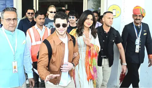  ?? — Reuters photos ?? Chopra and Jonas (above and below) wave as they arrive at the airport in Jodhpur, on Thursday.