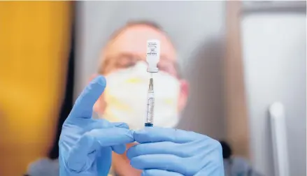  ?? NOAHBERGER/AP ?? A pharmacist draws saline while preparing a dose of COVID-19 vaccine last week in Sacramento, Calif. Virus mutations are causing concern.