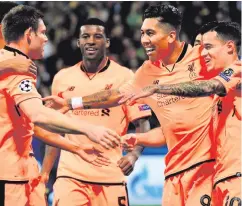  ??  ?? First of many: Roberto Firmino (second from right) takes the acclaim after opening the floodgates for Liverpool in Slovenia