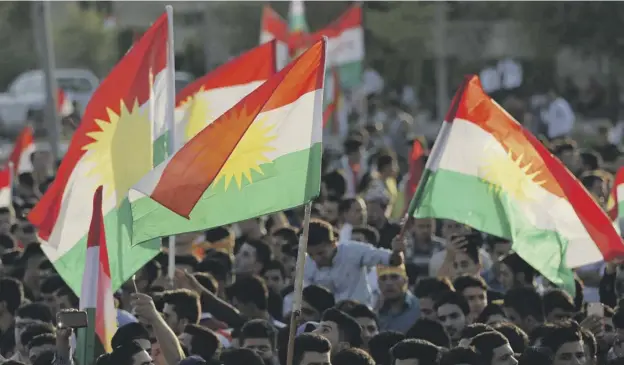  ??  ?? 0 Iraqi Kurds gather in Arbil, the capital of the Kurdish region, flying Kurdish flags as they urge people to vote in the upcoming independen­ce referendum