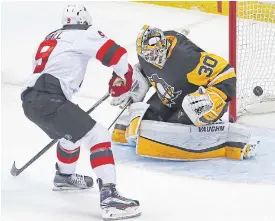  ??  ?? The Devils’ Taylor Hall, No.9, beats Penguins goaltender Matt Murray.