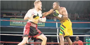  ?? CONTRIBUTE­D ?? Canada’s Ryan Young (left) and Jamaica’s Ramel Lewis battle in mid-ring during the eighth bout of the Wray & Nephew Contender series held at the Chinese Benevolent Associatio­n auditorium on Wednesday. Young won by a technical knockout.