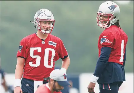  ?? Bob Breidenbac­h / TNS ?? Patriot quarterbac­ks Mac Jones (50) and Cam Newton work through a drill during training camp at Gillette Stadium in Foxborough, Mass.