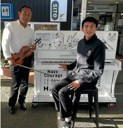  ?? CAROLINE WILLIAMS/STUFF ?? Jimmy Sun and his father Xiao Feng Sun take to Warkworth’s community piano to play music together.
