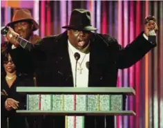  ?? — AP ?? In this Dec. 6, 1995, file photo, The Notorious B.I.G., who won rap artist and rap single of the year, clutches his awards at the podium during the annual Billboard Music Awards in New York.