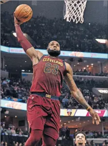  ?? [BRANDON DILL/THE ASSOCIATED PRESS] ?? Cleveland’s LeBron James rises for a dunk during Friday’s game against Memphis. CELTICS 110, PISTONS 98:
