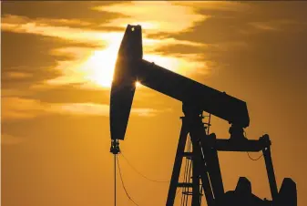  ?? Eli Hartman / Odessa (Texas) American ?? A pumpjack operates in April near Goldsmith, Texas. Lawmakers passed a measure that would restore rules aimed at limiting greenhouse gas emissions from oil and gas drilling facilities.