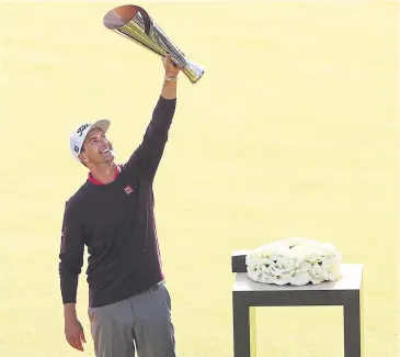  ?? AFP ?? Adam Scott poses with the trophy after winning the Genesis Invitation­al.