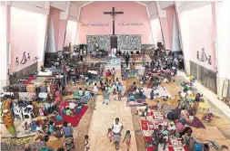  ?? TSVANGIRAY­I MUKWAZHI THE ASSOCIATED PRESS ?? Situated in the heart of an ethnically diverse city ravaged by Cyclone Kenneth, the Maria Auxiladora parish is housing 1,000 people displaced by the storm.