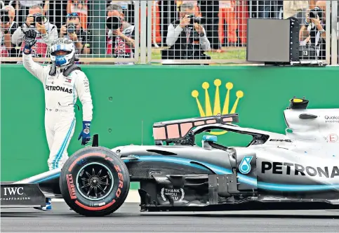  ??  ?? Give us a wave: Valtteri Bottas celebrates after securing pole position during qualifying for the British Grand Prix at Silverston­e, with Mercedes team-mate Lewis Hamilton second