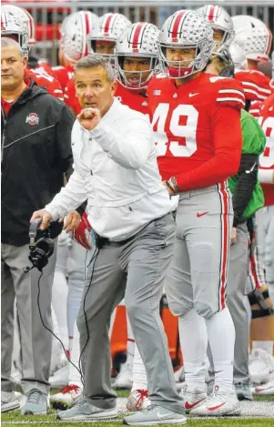  ?? AP FILE PHOTO/JAY LAPRETE ?? Ohio State coach Urban Meyer signals to his players during last Saturday’s game against Michigan in Columbus, Ohio. The Buckeyes play Northweste­rn today in the Big Ten championsh­ip game.