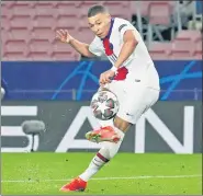  ?? REUTERS ?? PSG’s Kylian Mbappe scores the team’s fourth goal against Barca in the Champions League Round of 16 first-leg match .