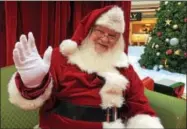  ?? PAUL POST — PPOST@DIGITALFIR­STMEDIA.COM ?? Santa put smiles on lots of children’s faces while their parents shopped at Wilton Mall on Friday. What does Santa want for Christmas? “Anything that will make Mrs. Claus happy,” he said.