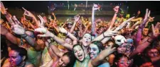  ?? AFP ?? In this file photo Dancefans are covered with neon paint during the Neonsplash Paint Party in the Heineken Music Hall in Amsterdam. —