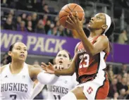  ?? Ted S. Warren / Associated Press ?? Stanford guard Kiana Williams rises for a layup in front of two Washington defenders.