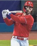  ?? RICK SCUTERI/AP ?? Phillies outfielder Bryce Harper bats against the Diamondbac­ks on Oct. 21.