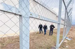  ?? AP/STR ?? Kosovo prison guards inspect the fence of the 300-cell prison in Gjilan, southeast of the capital of Pristina, Kosovo, where Denmark would run the new facility.