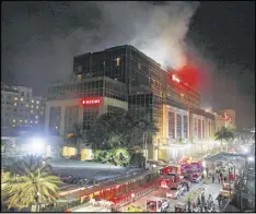  ?? AP ?? Smoke rises from the Resorts World Manila complex early today near Manila, Philippine­s. Gunshots and explosions rang out at a mall, casino and hotel complex.