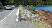  ?? PHOTO: MONIQUE FORD/FAIRFAX NZ ?? Shelly Bay Rd is six metres wide. The orange road cone – far right – shows where the edge would be if it became 22m wide.