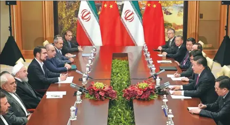  ?? WAN QUAN / FOR CHINA DAILY ?? President Xi Jinping meets Iranian President Hassan Rouhani on the sidelines of the 18th Shanghai Cooperatio­n Organizati­on Summit in Qingdao, Shandong province, on Sunday.