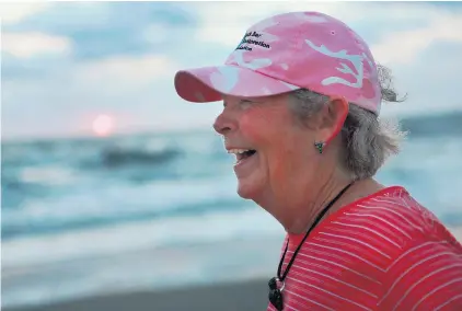  ?? VIRGINIAN-PILOT FILE PHOTO ?? Marian Childress chats with another sunrise regular in 2013 at the Virginia Beach Oceanfront. She taught elementary school for 30 years in Fairfax.