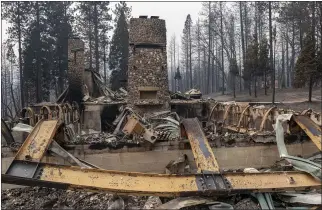  ?? ALIE SKOWRONSKI — SACRAMENTO BEE ?? The Camp Okizu chimneys stand in Berry Creek in September after the summer camp for children with cancer was burned by the Bear Fire.