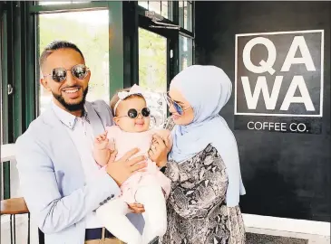  ?? Qawa Coffee Co / Contribute­d photo. ?? Qawa Coffee Co. co-owners Abdul Alhadheri, left, and his wife, Amirah Ailaqi, hold their daughter at the 170 Main St., Middletown, cafe.