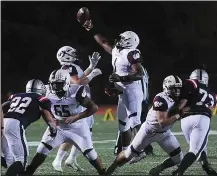  ?? Photos by Ernest A. Brown ?? LEFT, Woonsocket quarterbac­k Tarik Robinson-O’Hagan (1) tries to get a grip on the ball after it was snapped over his head. RIGHT, Lincoln quarterbac­k Randall Hien finished with two rushing touchdowns as the Lions defeated the Villa Novans, 26-0.