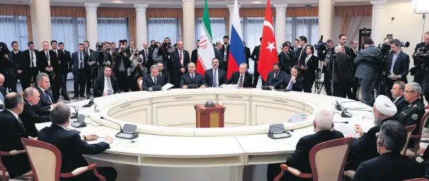  ??  ?? Presidents Erdoğan (C), Putin (L) and Rouhani (R), accompanie­d by their delegation­s, hold a meeting on the Syrian peace process, in the Black Sea resort of Sochi, Russia, Feb. 14, 2019.