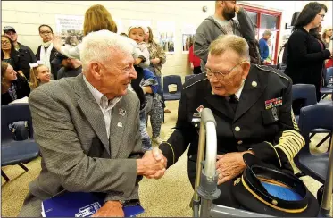  ?? NWA Democrat-Gazette/FLIP PUTTHOFF ?? E.S. Lawbaugh of Fayettevil­le (left), Marine Corps veteran, and Army veteran Lucion Cowart of Rogers chat Friday at a Veterans Day performanc­e by students at Westside Elementary School in Rogers. Lawbaugh was keynote speaker at the event. Students sang...