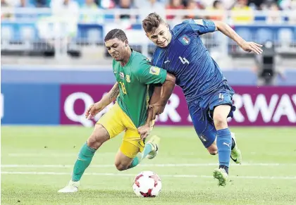  ?? / KOJI WATANABE/GETTY IMAGES ?? Amajita’s Grant Magerman tries to get ahead of Nicolo Barella of Italy during their U-20 World Cup Group D match at Suwon in South Korea yesterday.