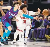  ?? Jonathan Daniel Getty Images ?? LaMELO BALL, left, and Lonzo Ball faced off Monday night, with the Bulls beating the Hornets 133-119.