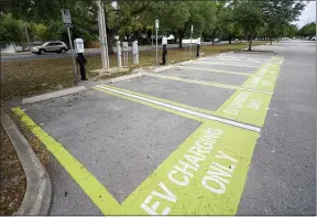 ?? JOHN RAOUX — THE ASSOCIATED PRESS ?? Parking spots with charging stations for electric vehicles at a public park in Orlando, Fla.