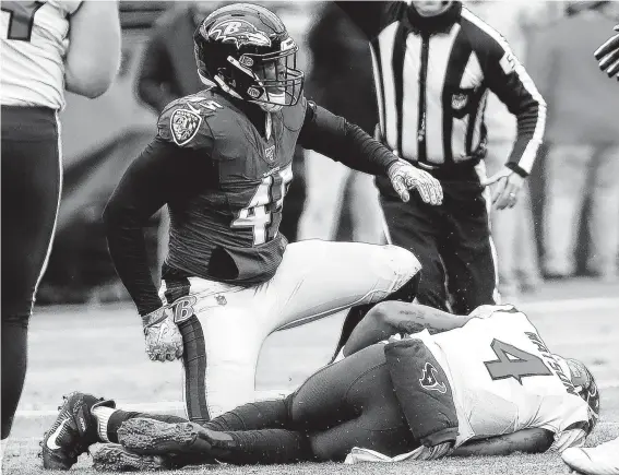  ?? Photos by Brett Coomer / Staff photograph­er ?? Texans quarterbac­k Deshaun Watson (4) lies on the turf after he was sacked by Ravens linebacker Jaylon Ferguson during Baltimore’s easy victory Sunday.