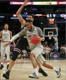  ?? JULIE JACOBSON — THE ASSOCIATED PRESS ?? Penn State’s Shep Garner (33) drives against Mississipp­i State’s Quinndary Weatherspo­on during the NIT semifinals on Tuesday in New York. Garner scored 18, and Penn State won, 75-60.