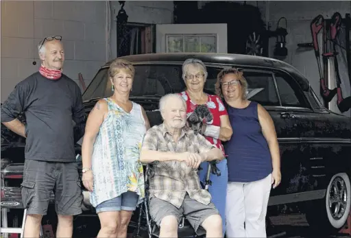  ?? Will Waldron / Times Union ?? James Kennedy, 80, center, is surrounded by family members James Kennedy, left, Kathy Becker, his wife Charlotte, second from right, and Tracy Davey, right, as they gather around his classic 1953 Mercury at his garage in Halfmoon. Kennedy is recovering from a heart condition through the aid of home health care.