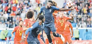  ?? — AFP photo ?? France’s defender Samuel Umtiti (top) heads the ball to score the opening goal during the World Cup semi-final football match between France and Belgium at the Saint Petersburg Stadium in Saint Petersburg.