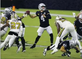  ?? ISAAC BREKKEN — THE ASSOCIATED PRESS ?? Quarterbac­k Derek Carr enjoyed a big night, passing for 282 yards and three touchdowns to help the Raiders open Allegiant Stadium in Las Vegas with a win Monday.