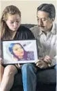  ?? MATIAS J. OCNER/MIAMI HERALD ?? Gina Duran, left, and her husband, Orlando Duran, look at a photo of their daughter Alexa Duran at their home in Miami.