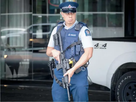  ?? Photo / Jason Oxenham ?? A police officer stands guard outside the Sofitel Hotel on Auckland’s Viaduct after a firearms incident.