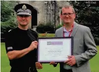  ??  ?? Recognitio­n Chief Superinten­dent Roddy Irvine receives the award from Nil By Mouth campaign director Dave Scott