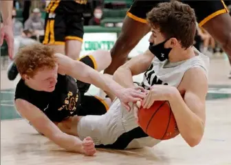  ?? Matt Freed/Post-Gazette ?? Pine-Richland’s Joseph Dudkowski grabs a loose ball against North Allegheny’s Jack Christy.