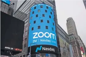  ?? AP FILE PHOTO/ MARK LENNIHAN ?? A sign for Zoom Video Communicat­ions is seen ahead of the company’s Nasdaq IPO in New York. Zoom has become a staple during the coronaviru­s pandemic because it allows people to meet online rather than in person.
