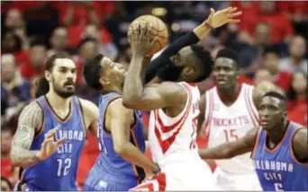  ?? DAVID J. PHILLIP — THE ASSOCIATED PRESS ?? Houston’s James Harden (13) drives toward the basket as Oklahoma City’s Andre Roberson, second from left, defends during the first half in Game 5 Tuesday in Houston.