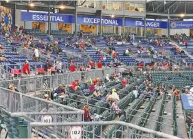  ?? STAFF PHOTOS BY C.B. SCHMELTER ?? Fans sit in the stands on opening day at AT&T Field on Tuesday.