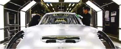  ??  ?? A car is assembled at the BMW Mini car production plant in Oxford. Political and economic uncertaint­y, not least from Brexit, sent sales of new cars in Britain falling sharply in September, a key month for the industry. (AFP)