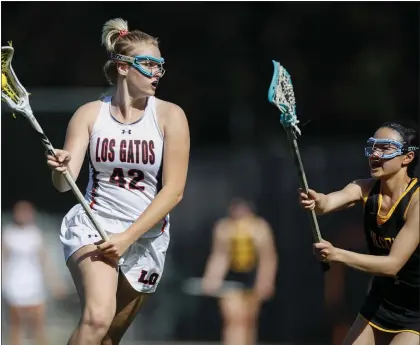  ?? NHAT V. MEYER — STAFF PHOTOGRAPH­ER ?? Los Gatos' Keira Dodd (42) controls the ball against Wilcox's Tiana Tran (4) in the first half on an April 6lacrosse match at Los Gatos High School. The Wildcats remained undefeated entering this week.