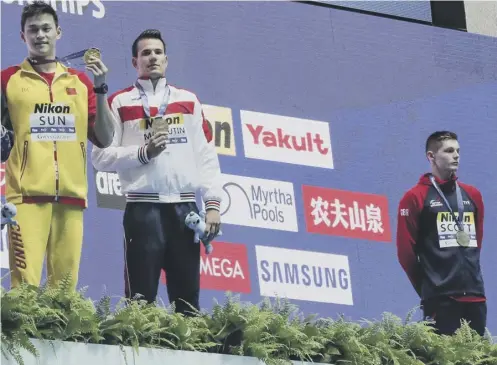  ?? PICTURE: LEE JIN-MAN/AP ?? 0 Duncan Scott refused to pose for pictures on the podium next to China’s Sun Yang after the 200m freestyle .
