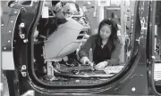  ?? CARLOS OSORIO/ASSOCIATED PRESS ARCHIVES ?? An assembly line worker assembles a 2017 Chrysler Pacifica in Windsor, Ontario. Chrysler is dropping Takata airbags.